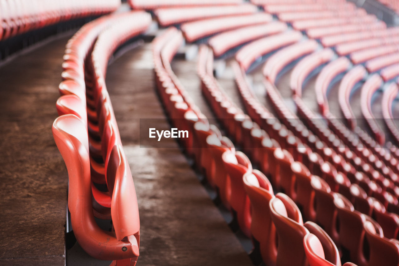 Rows of red seats in sports stadium