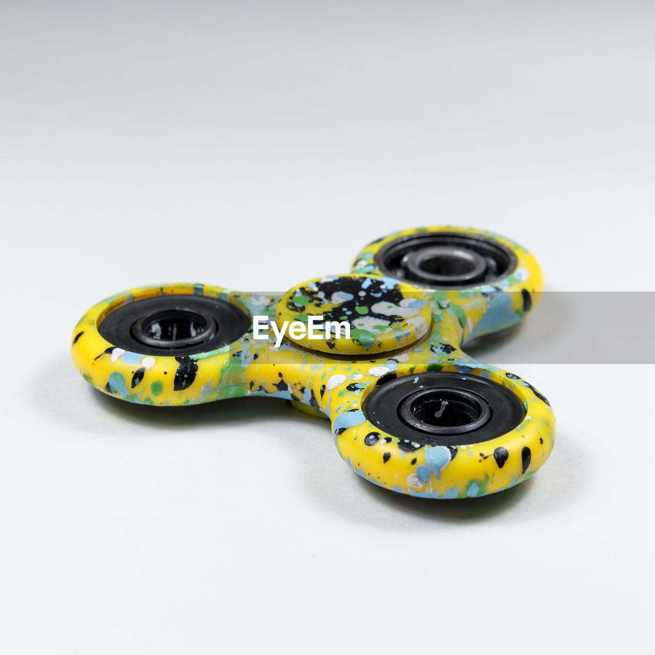 High angle view of fidget spinner over white background