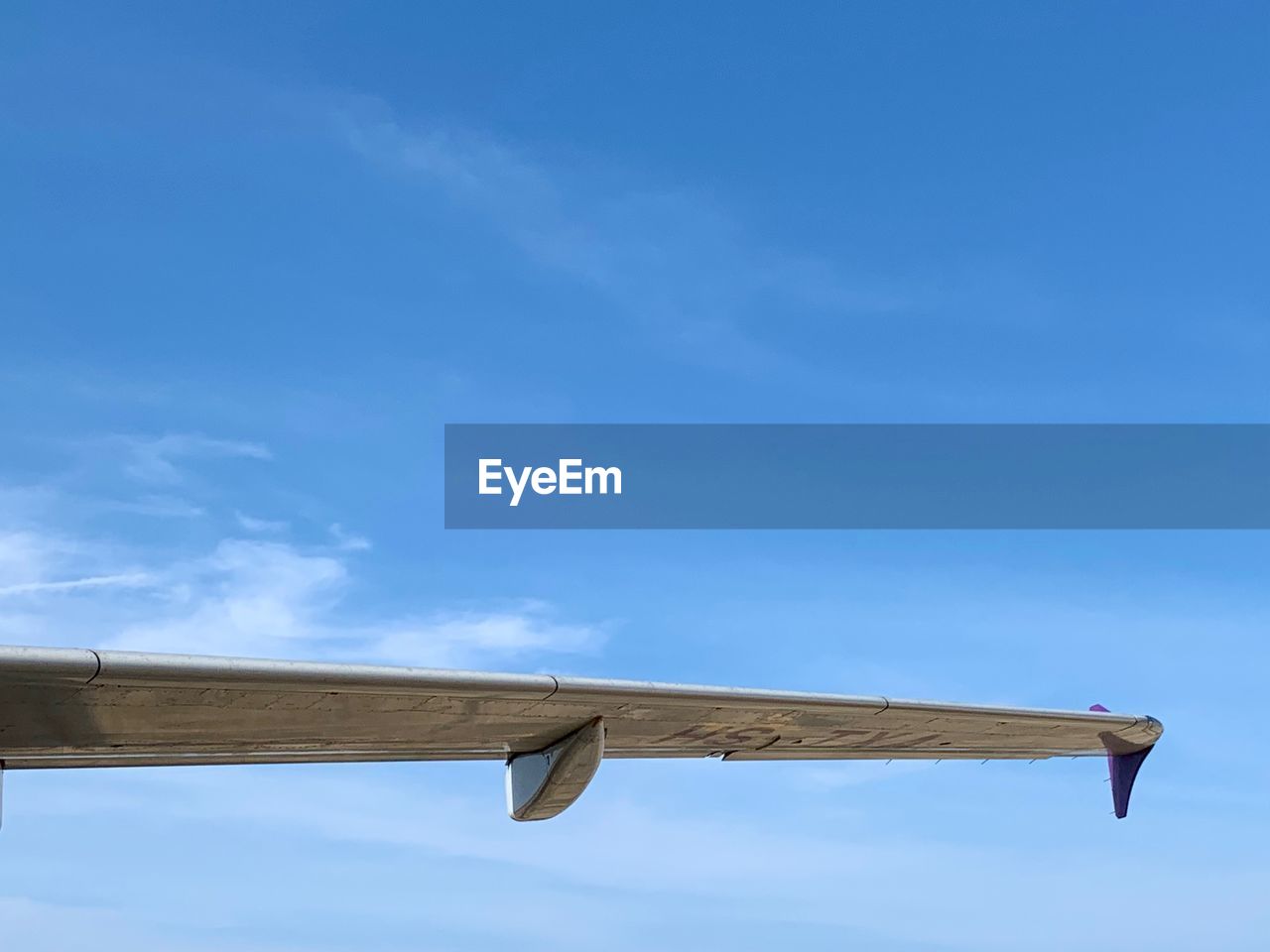 LOW ANGLE VIEW OF AIRPLANE ON ROOF AGAINST BLUE SKY