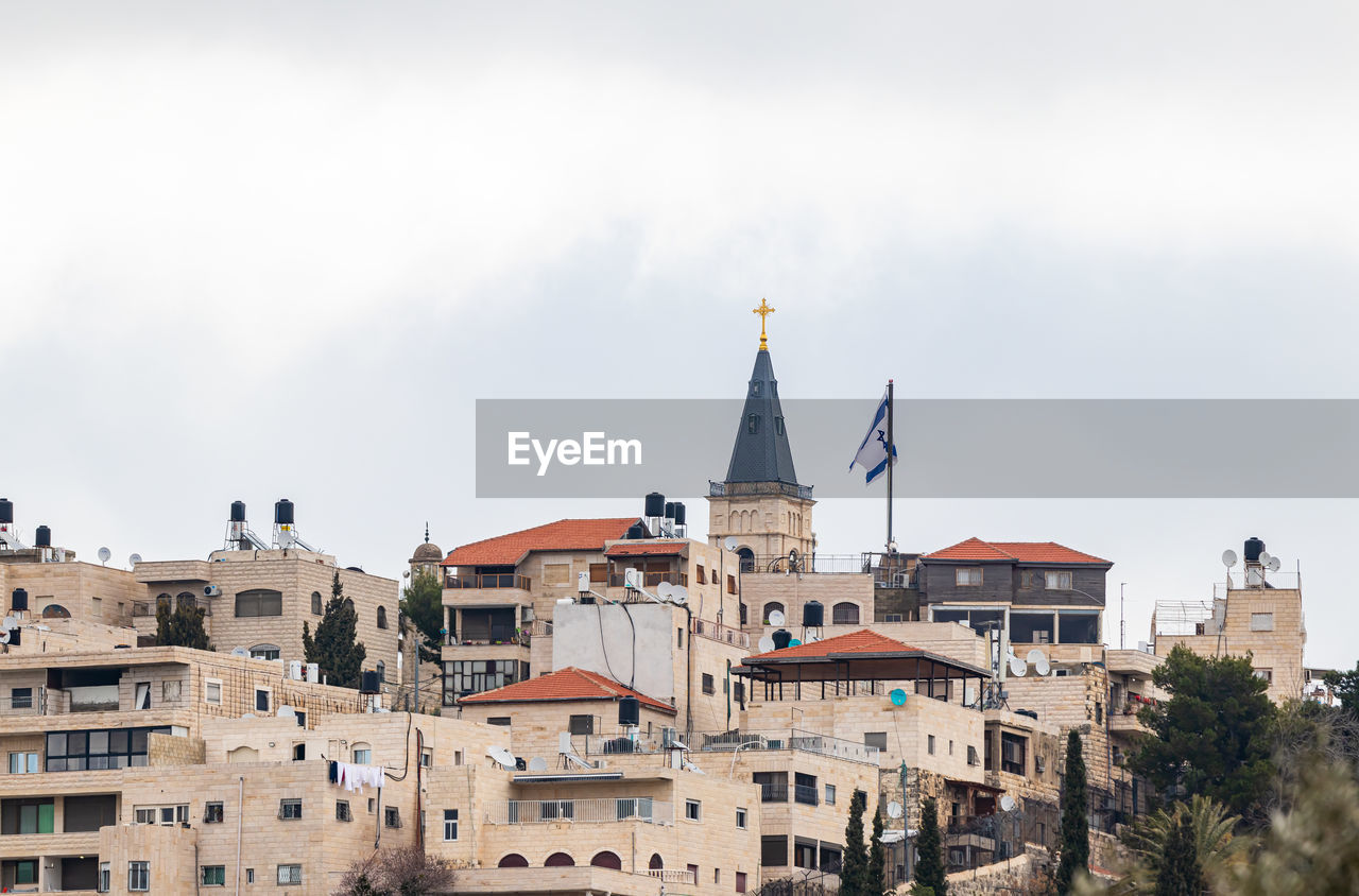 Low angle view of church in city against sky