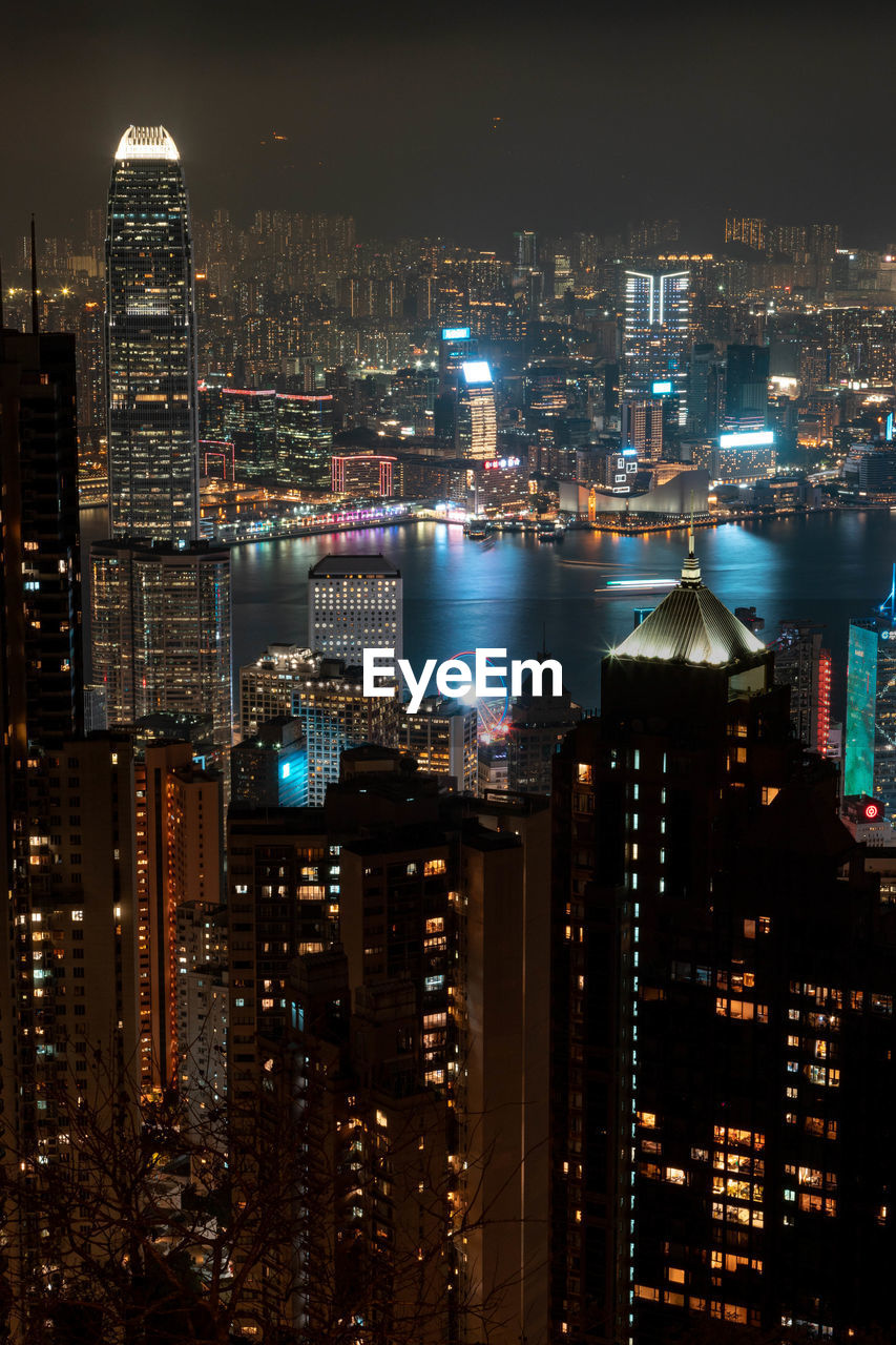 high angle view of illuminated buildings in city at night