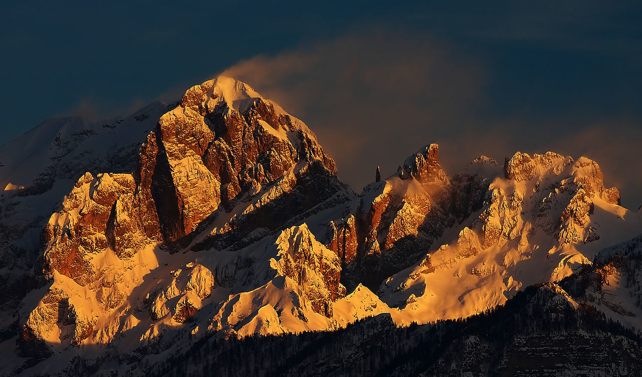 Scenic view of snowcapped mountain at sunset