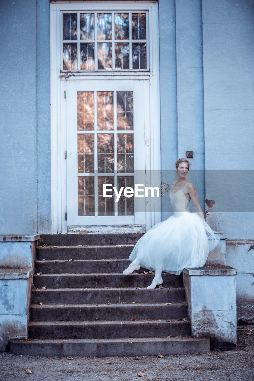 Ballet dancer sitting at entrance