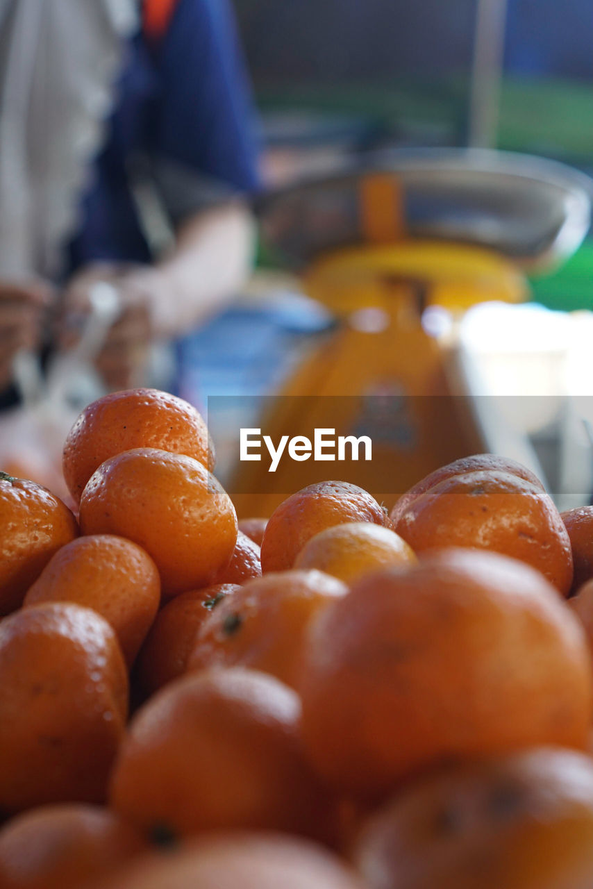 Close-up of orange fruits at market for sale