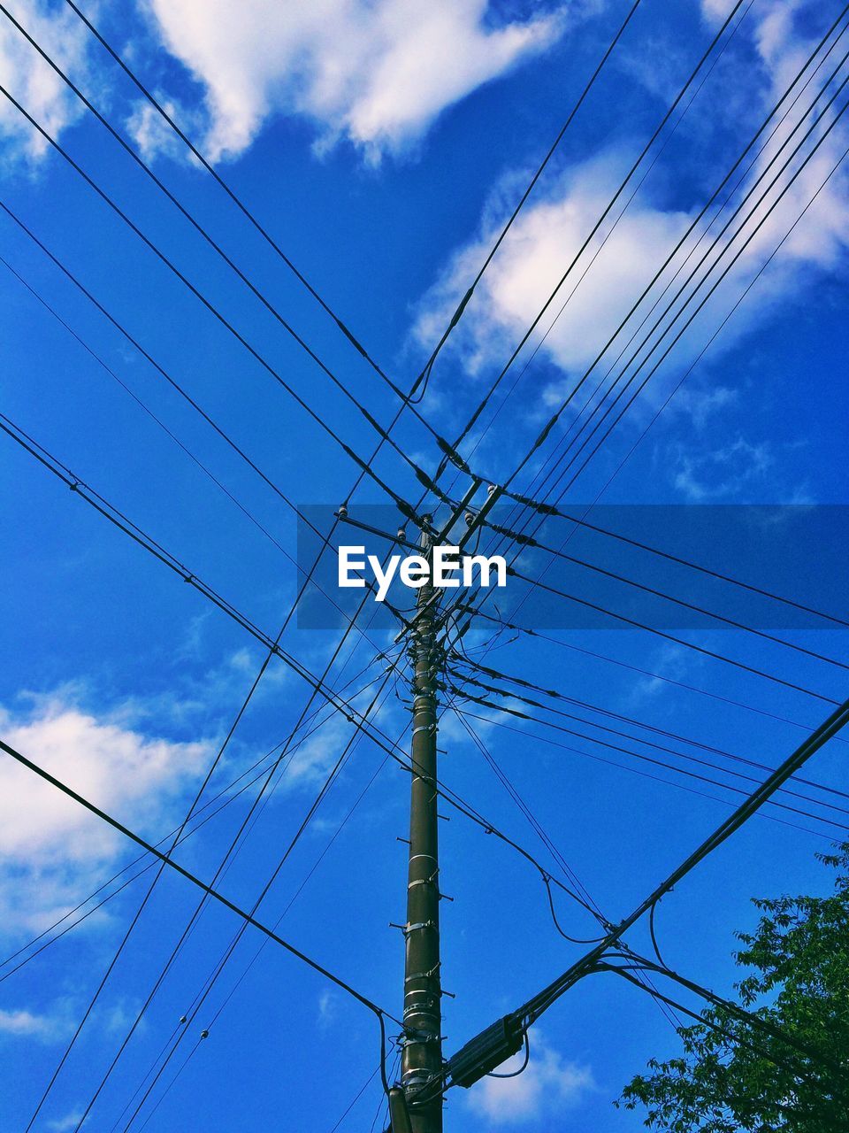 Low angle view of electricity pylon against sky