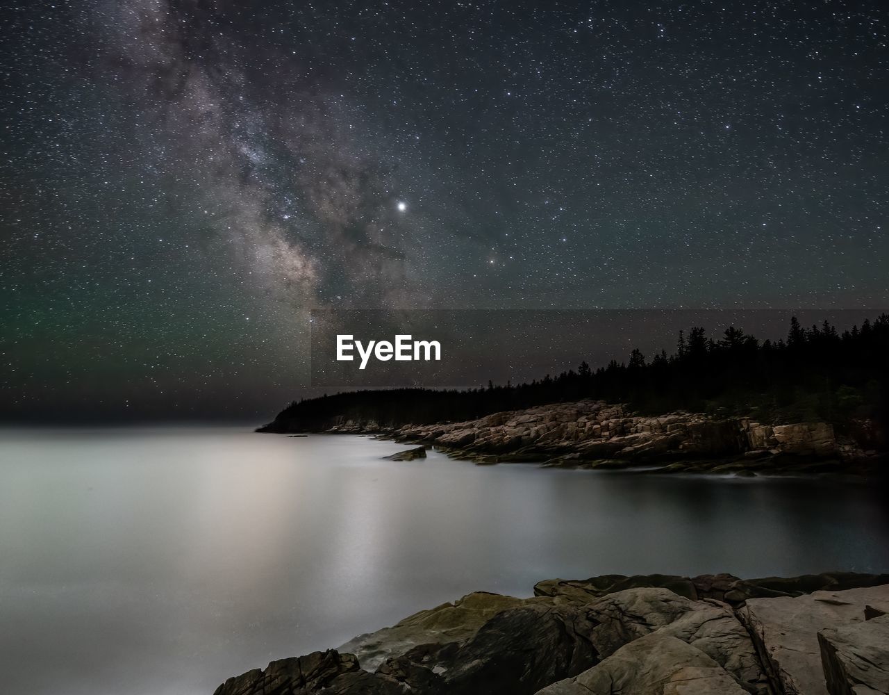 Scenic view of lake against sky at night