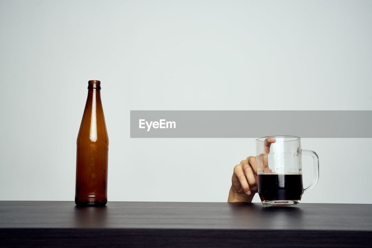 CLOSE-UP OF BEER GLASS ON TABLE