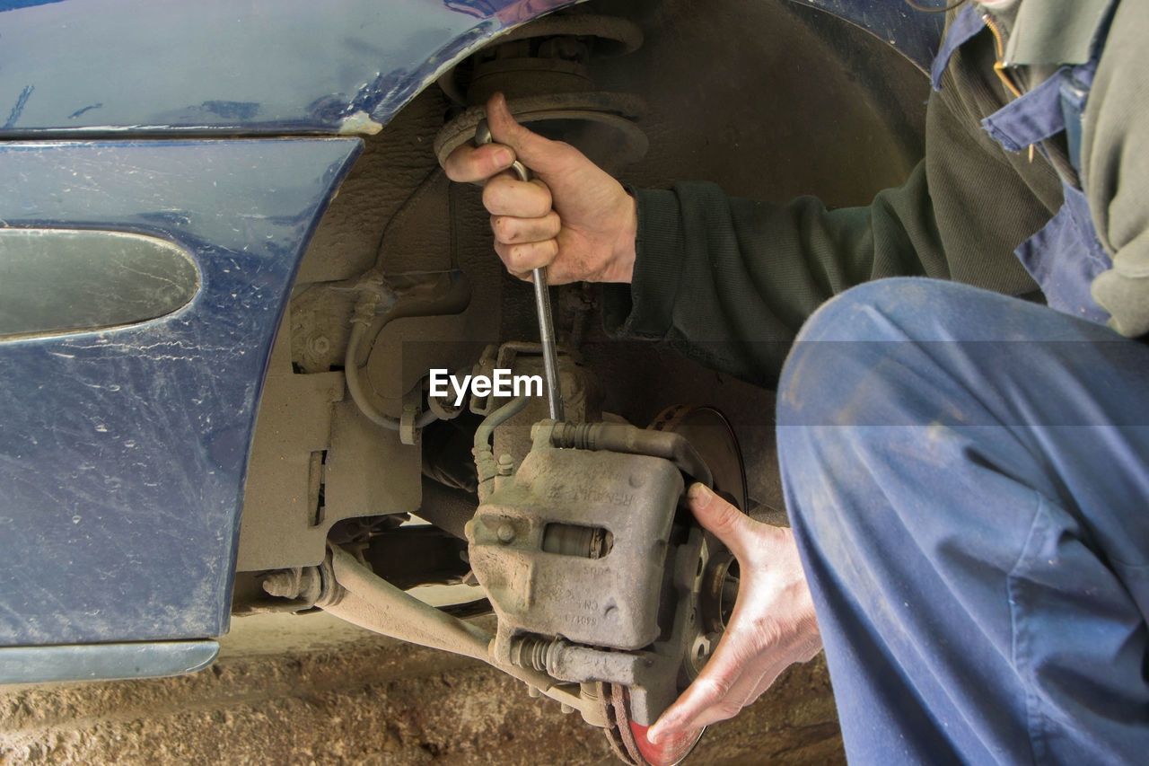 MAN WORKING AT CAR