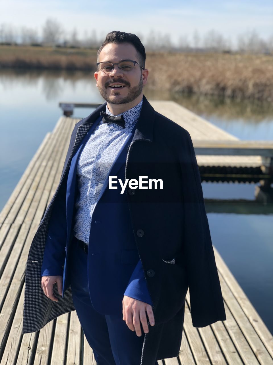 PORTRAIT OF YOUNG MAN STANDING IN LAKE