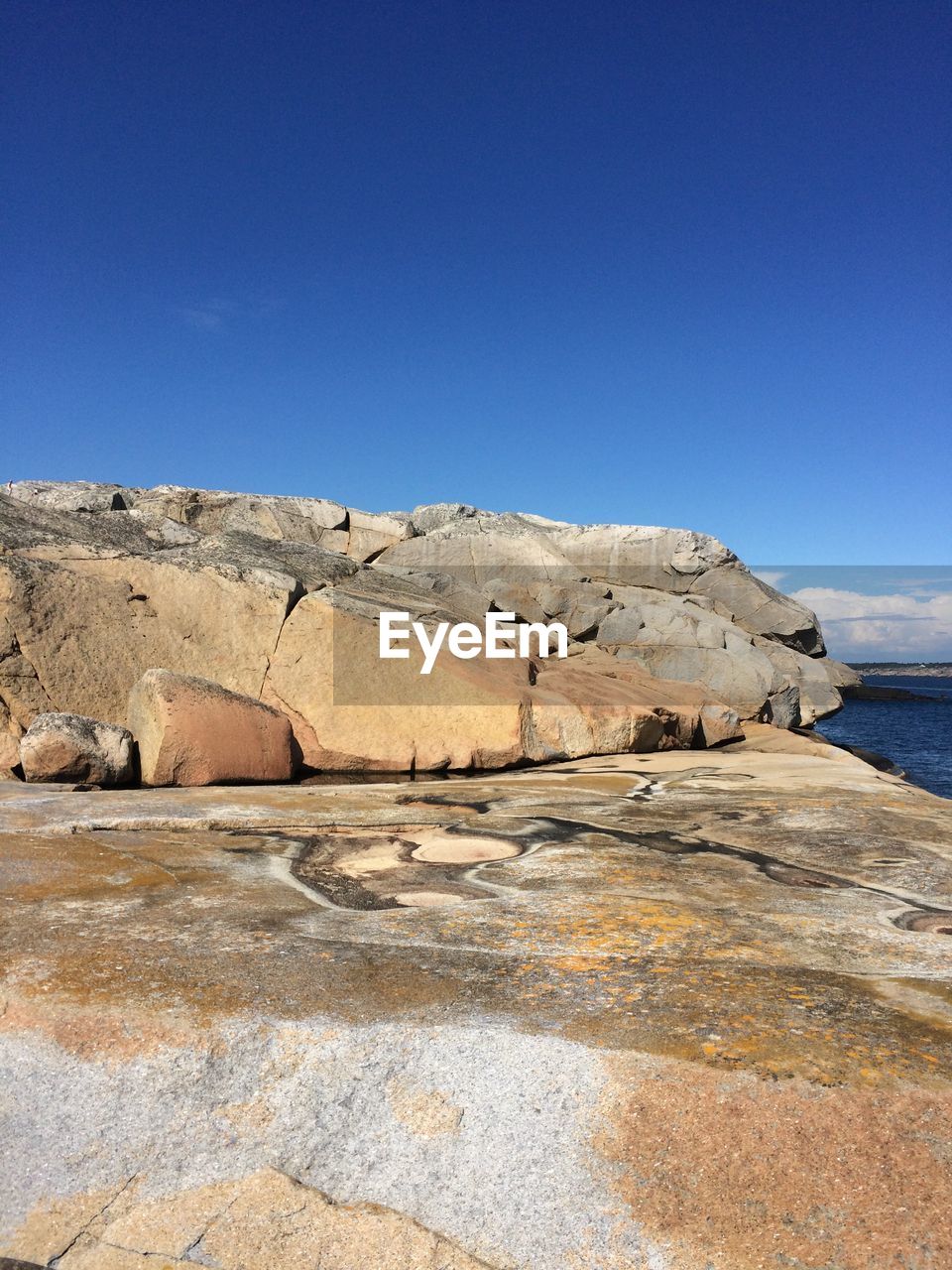 Scenic view of sea against clear blue sky