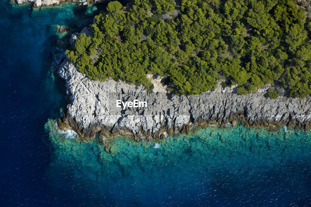 High angle view of rocks by sea