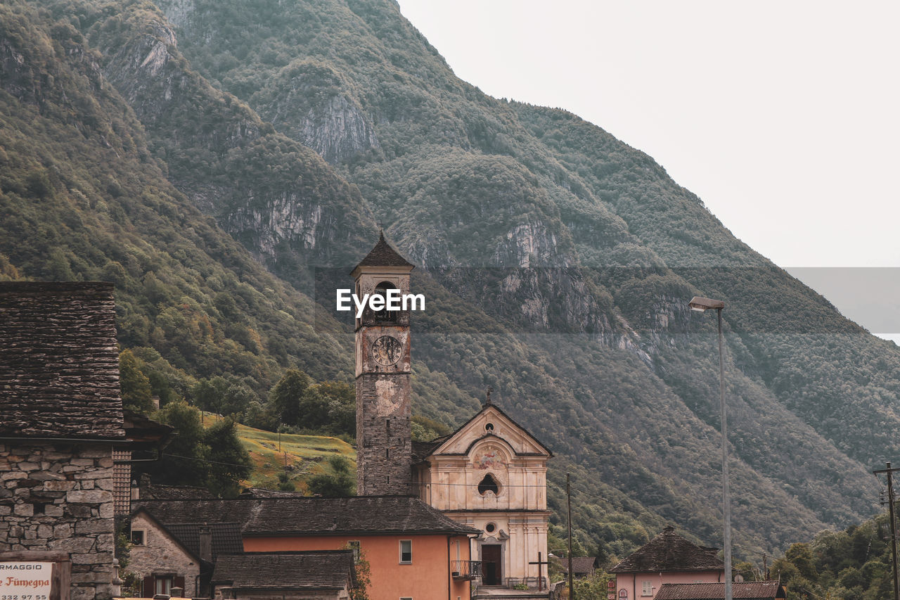 Historic building by mountains against sky