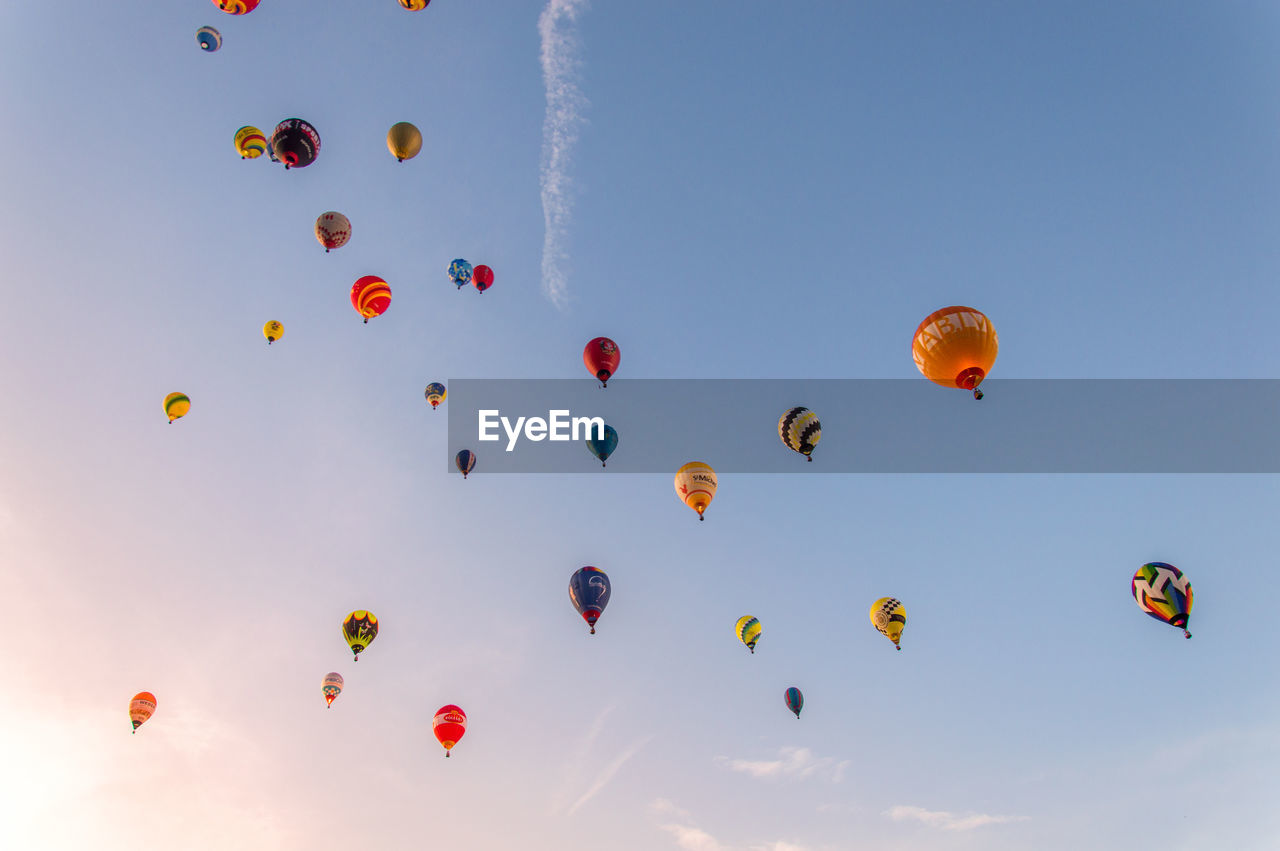 LOW ANGLE VIEW OF BALLOONS IN SKY