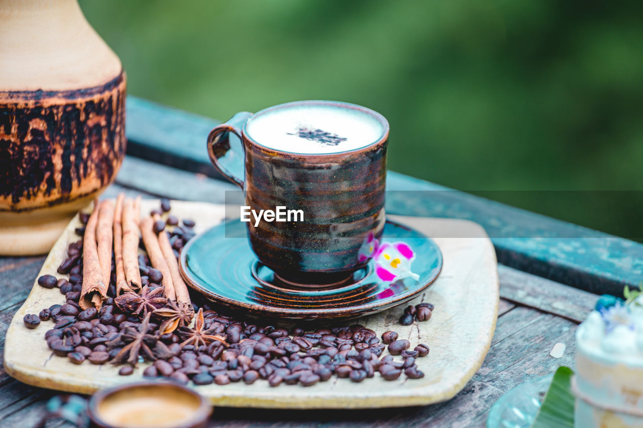 food and drink, drink, food, refreshment, cup, coffee cup, crockery, hot drink, mug, tea, table, coffee, no people, freshness, saucer, wood, plate, outdoors, healthy eating, nature, tea cup, ceramic, close-up, wellbeing, day