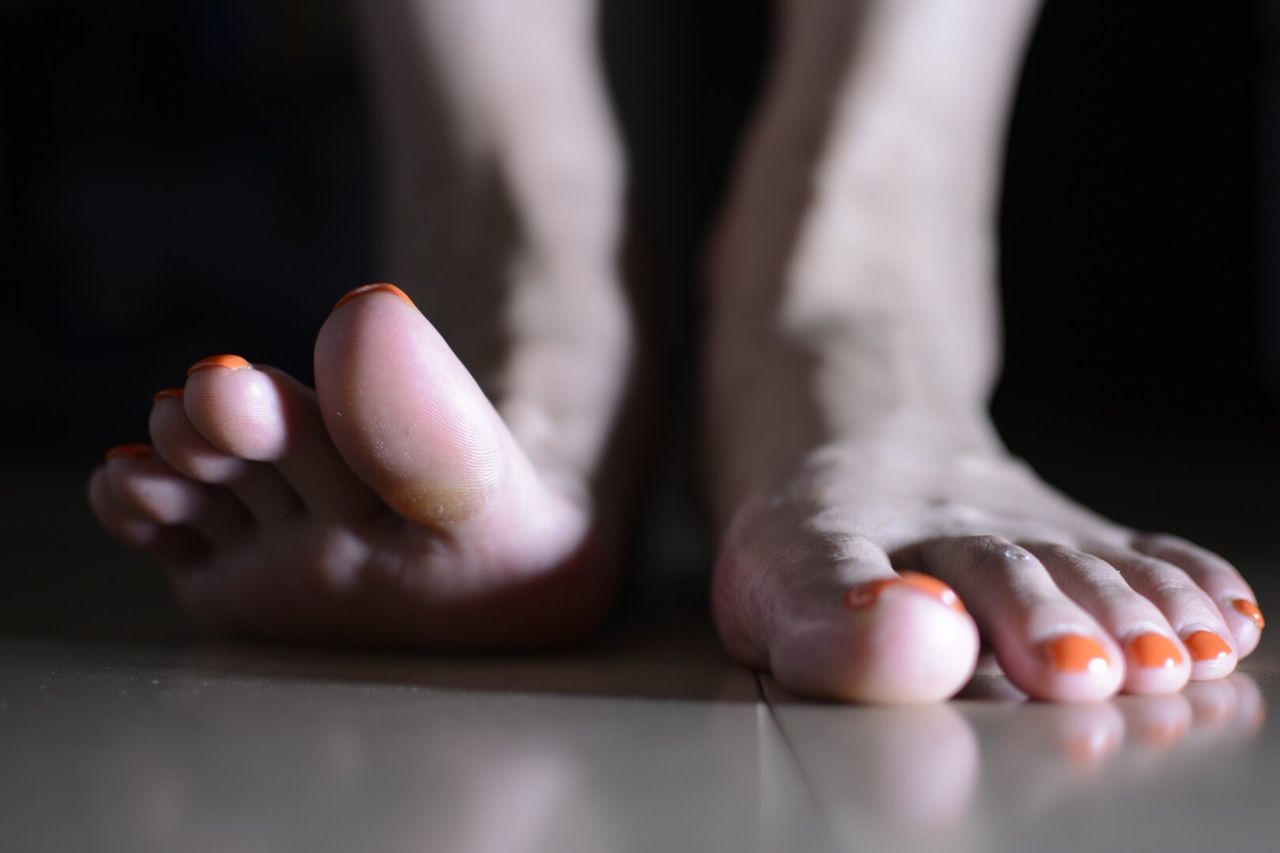 Low section of woman on floor at home