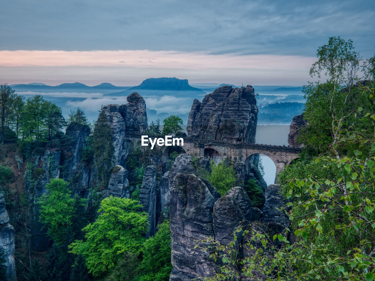 View of bastei bridge against cloudy sky