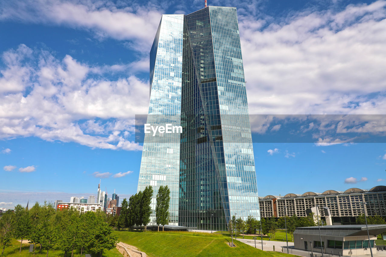 Low angle view of buildings against cloudy sky