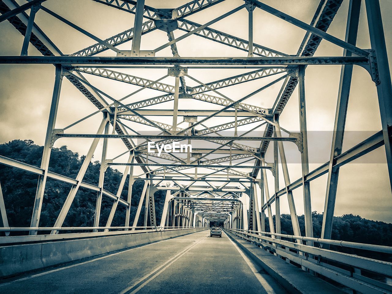 Car on bridge against sky