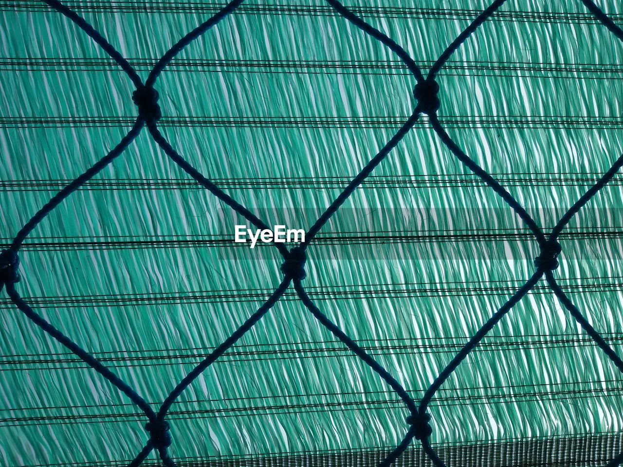 CLOSE-UP LOW ANGLE VIEW OF CHAINLINK FENCE
