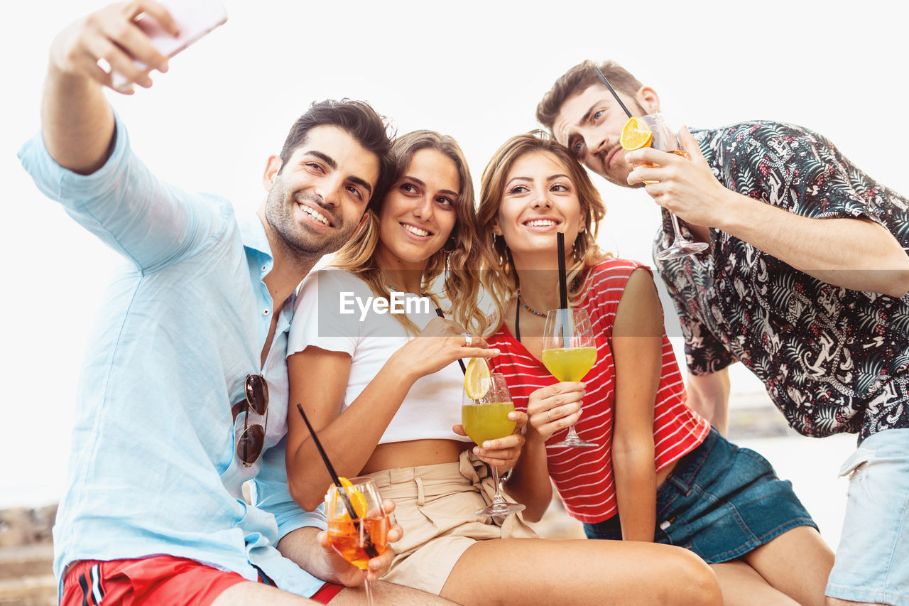 YOUNG COUPLE IN A TRADITIONAL CLOTHING DRINKING GLASSES