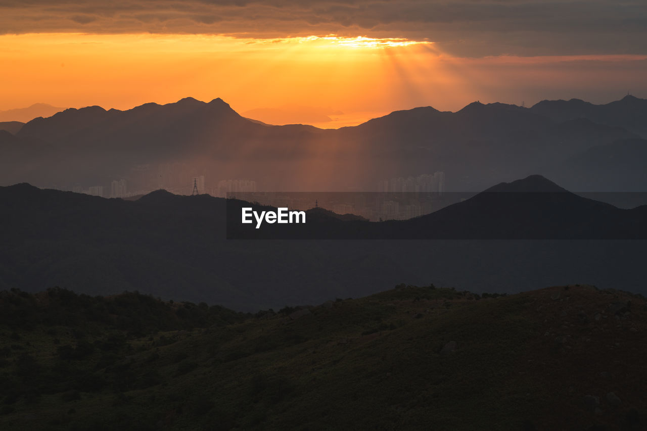 Scenic view of silhouette mountains against sky during sunset