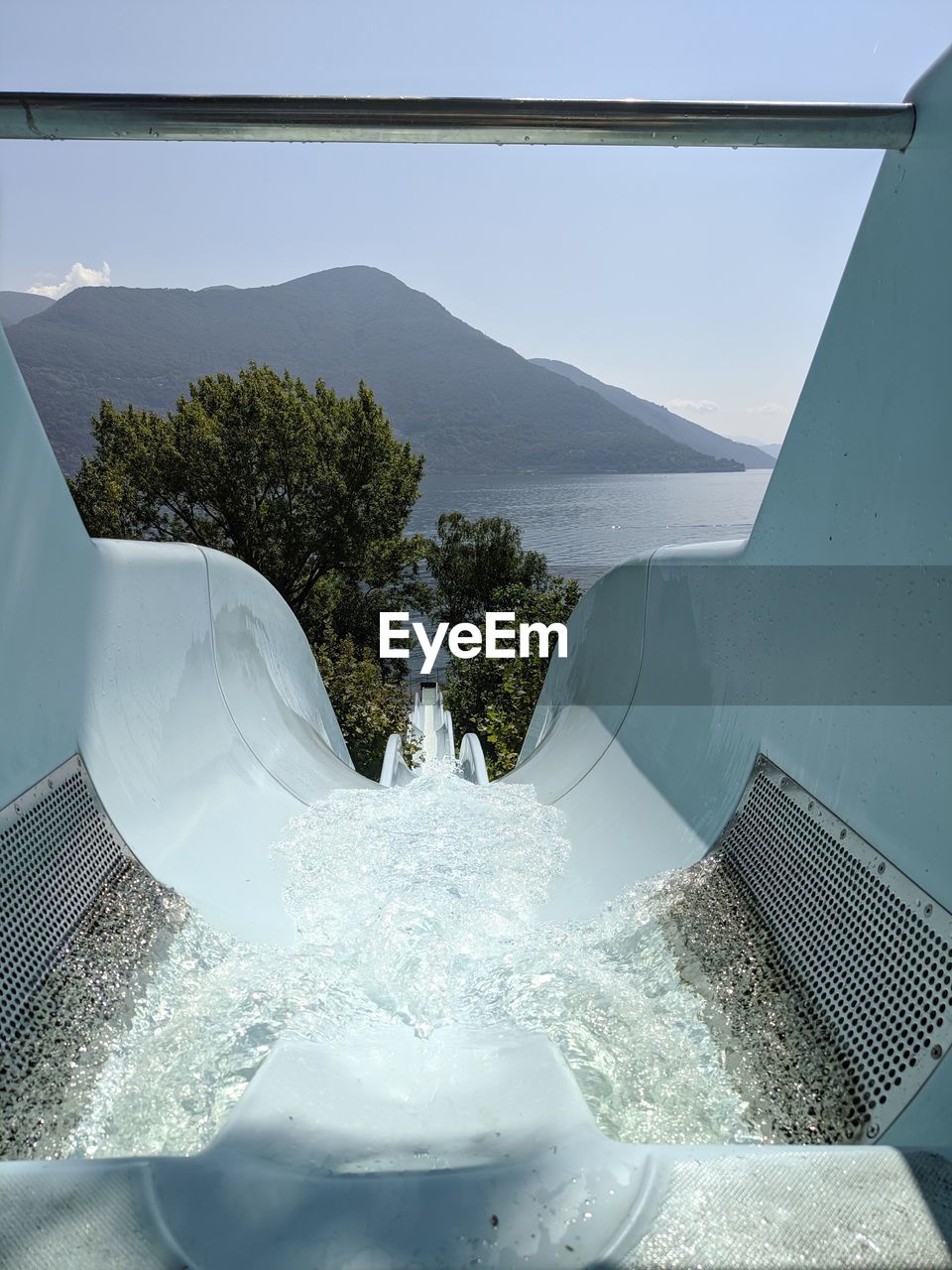 SCENIC VIEW OF SWIMMING POOL AGAINST MOUNTAINS