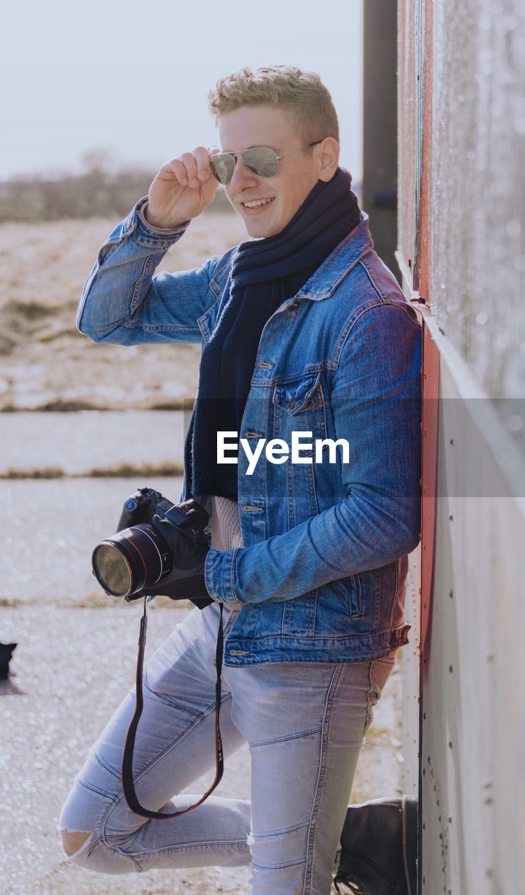 Full length of young man photographing with camera