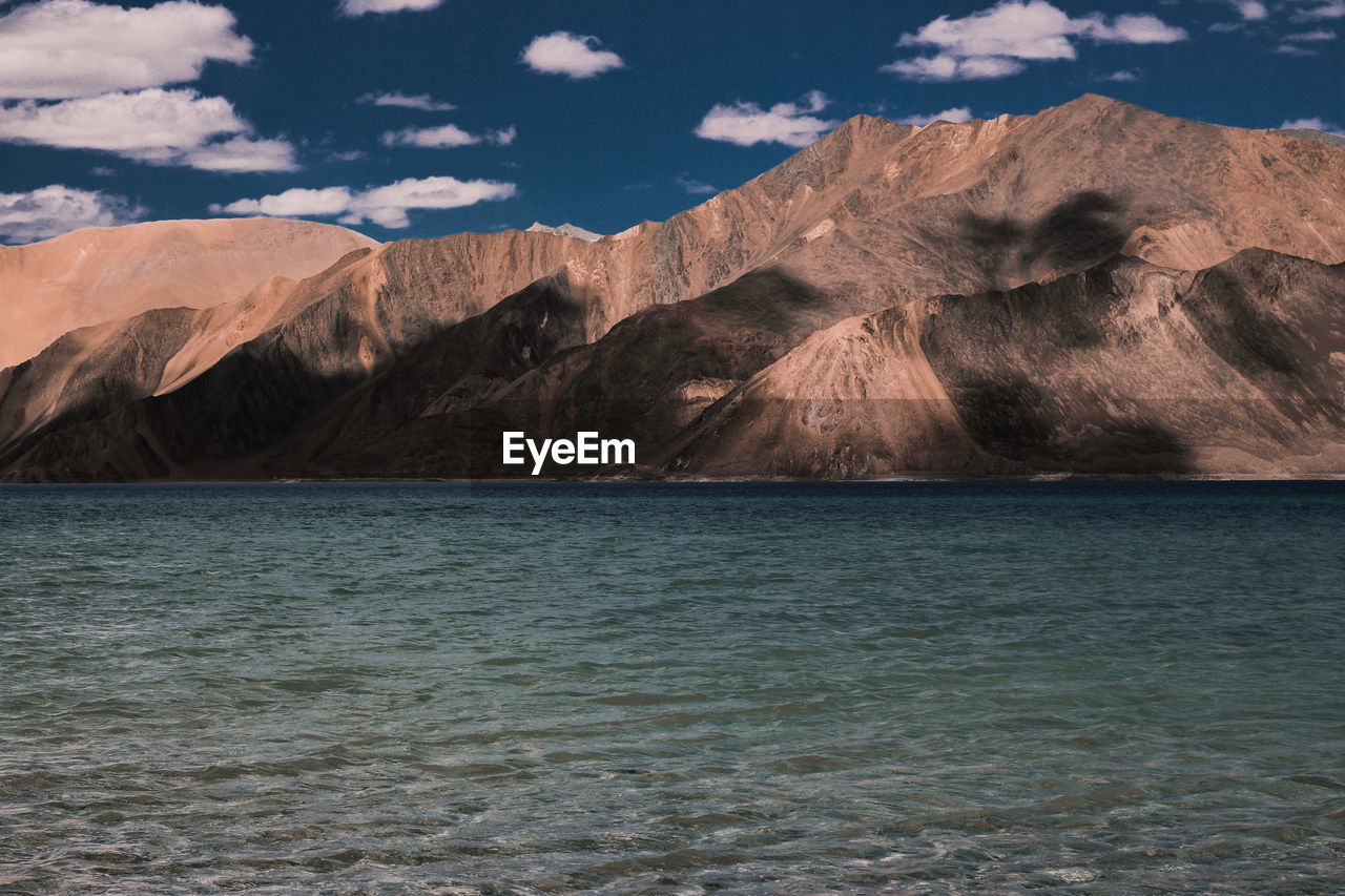 Scenic view of sea against cloudy sky