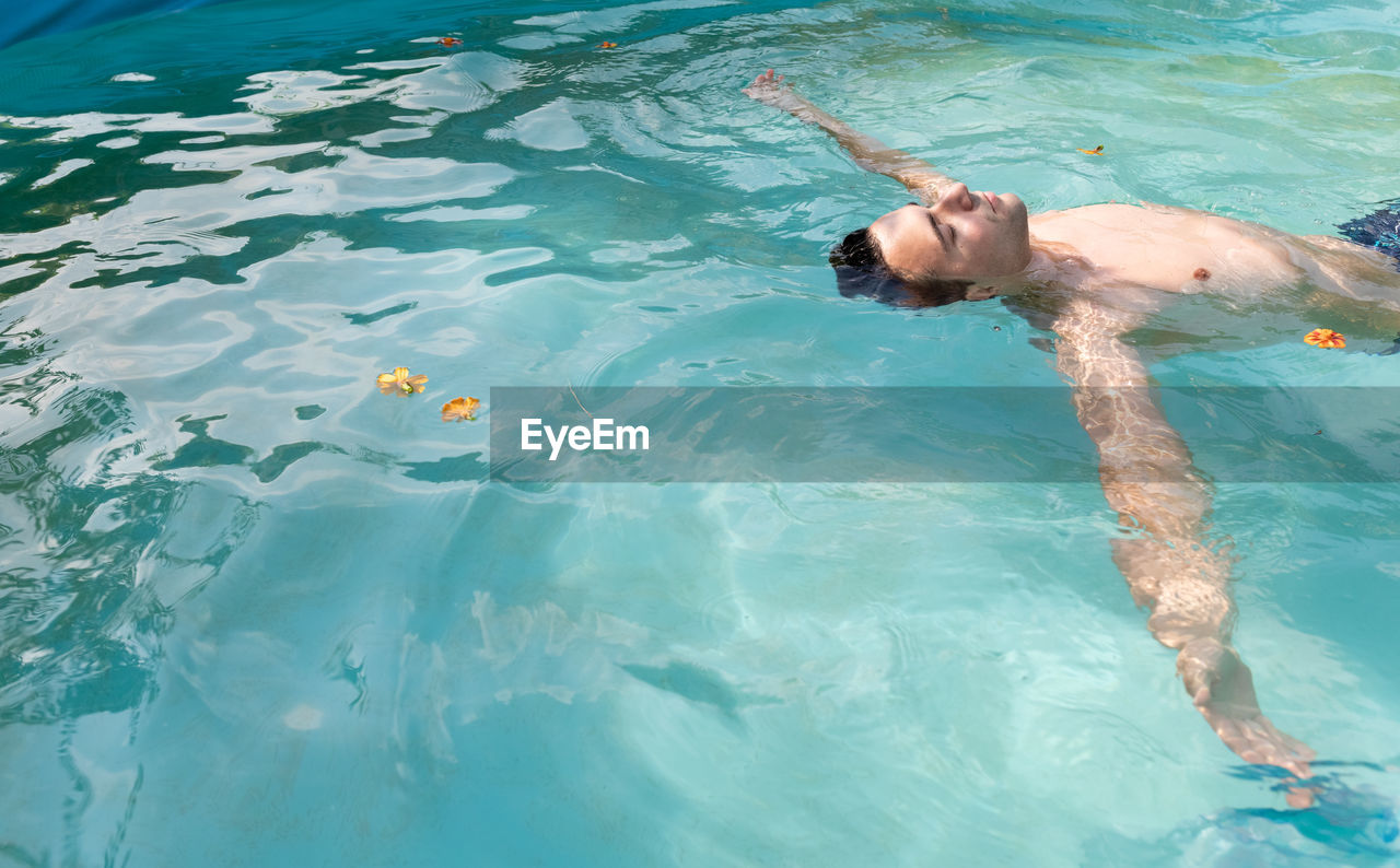 High angle view of man swimming in pool