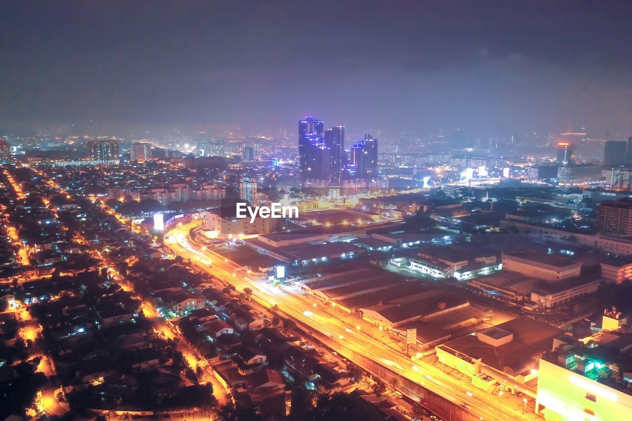 High angle view of illuminated buildings in city at night