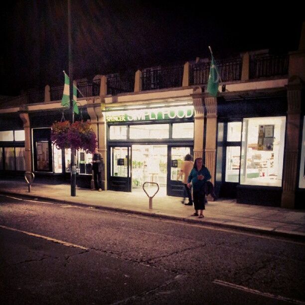 WOMAN WALKING IN CITY AT NIGHT