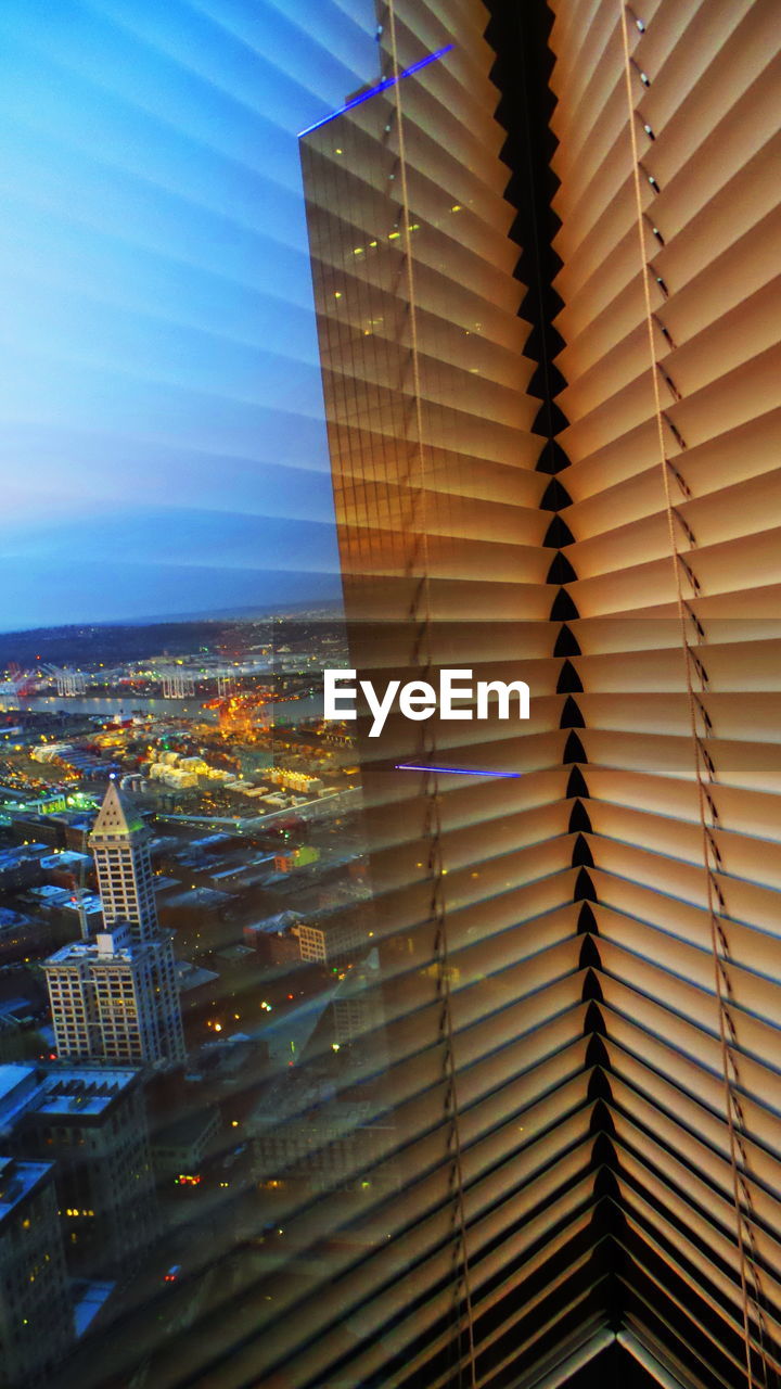 LOW ANGLE VIEW OF ILLUMINATED MODERN BUILDINGS