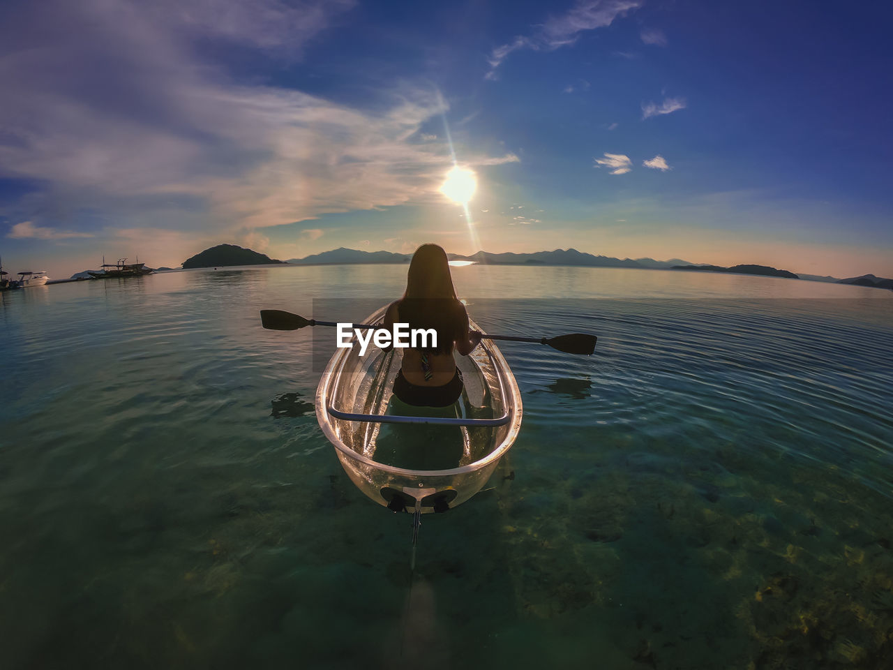 Rear view of woman on boat in sea