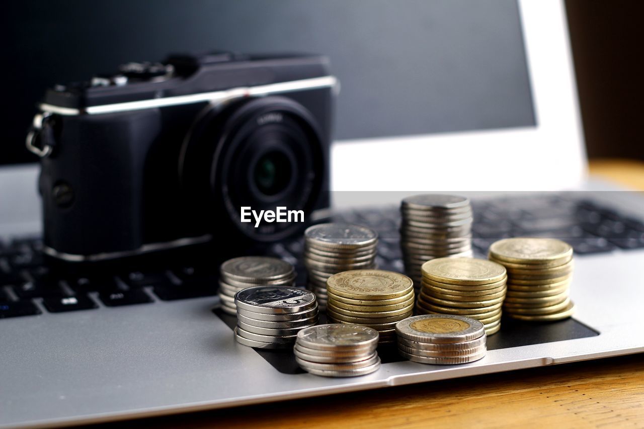 Close-up of coins on laptop against camera