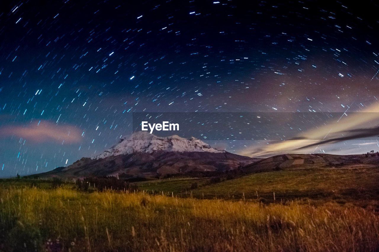 SCENIC VIEW OF MOUNTAINS AGAINST SKY AT NIGHT