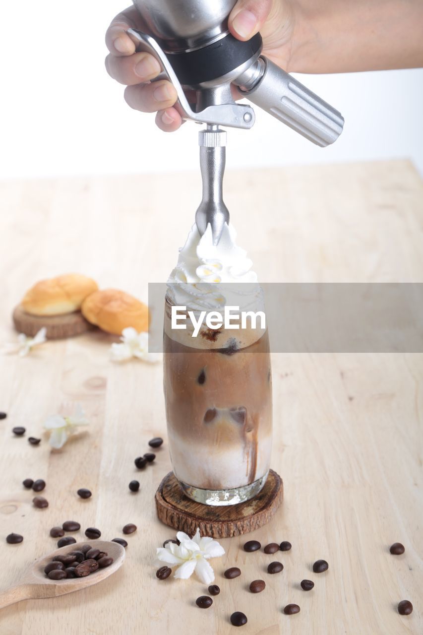 CLOSE-UP OF POURING COFFEE IN CUP