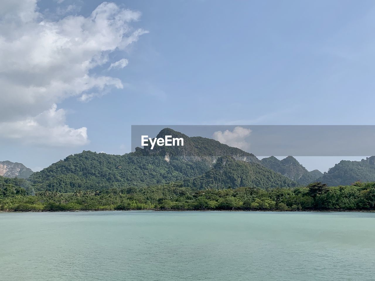 Scenic view of sea and mountains against sky