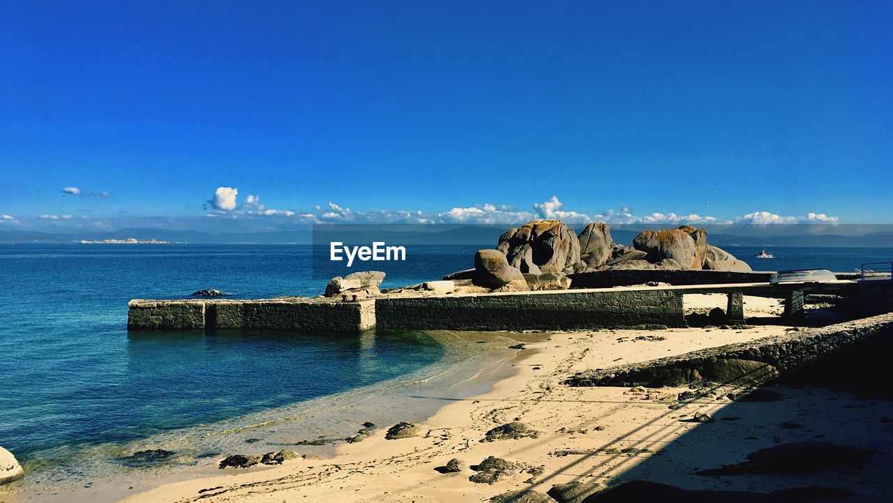 Scenic view of sea against blue sky