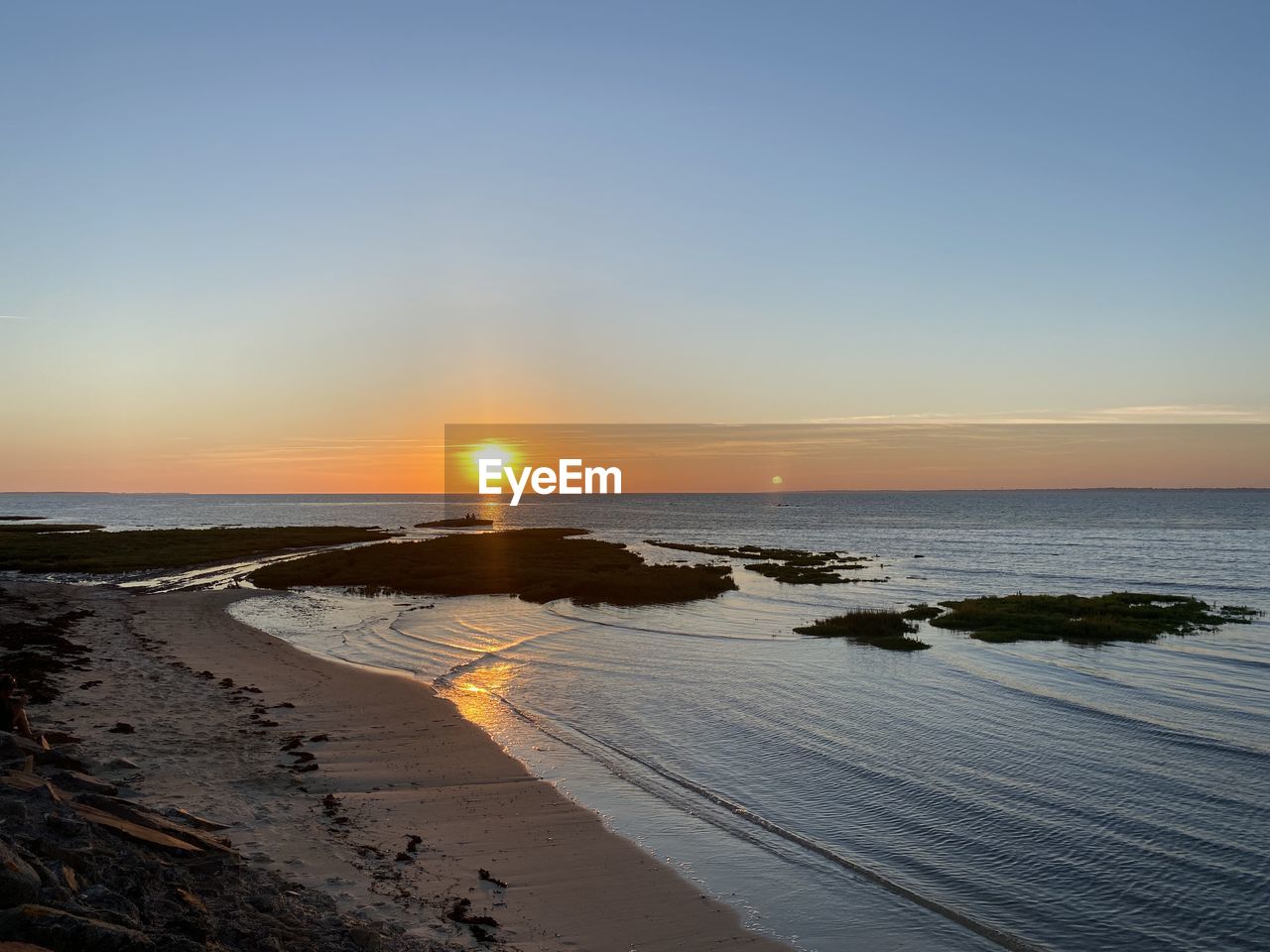 Scenic view of beach against sky during sunset
