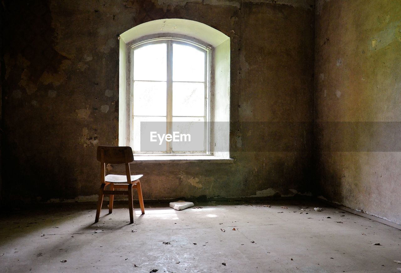 Empty chair in abandoned building