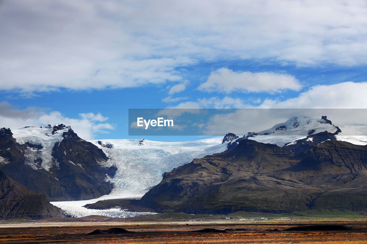 Scenic view of snowcapped mountains against sky