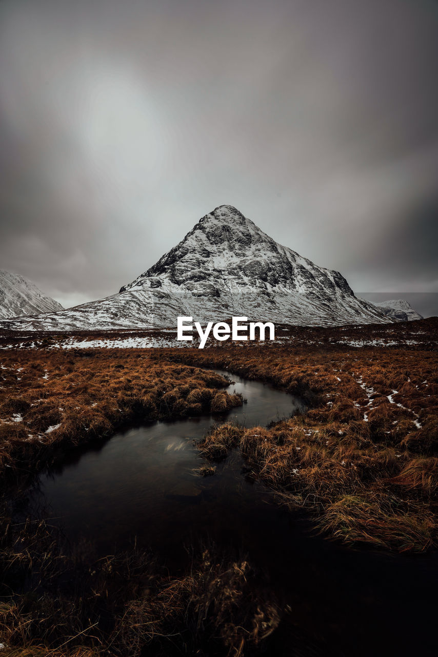 Mountains in rannoch moor in scotland scenic viev with lake and dark cloudy mood sky