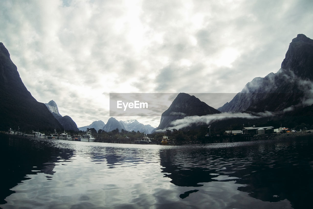 Scenic view of lake against cloudy sky