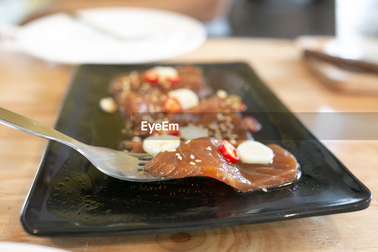 food and drink, food, meal, dish, healthy eating, cuisine, indoors, freshness, table, produce, wellbeing, no people, breakfast, eating utensil, kitchen utensil, focus on foreground, lunch, plate, close-up, selective focus, seafood, wood, tableware, fruit, spoon, still life, asian food
