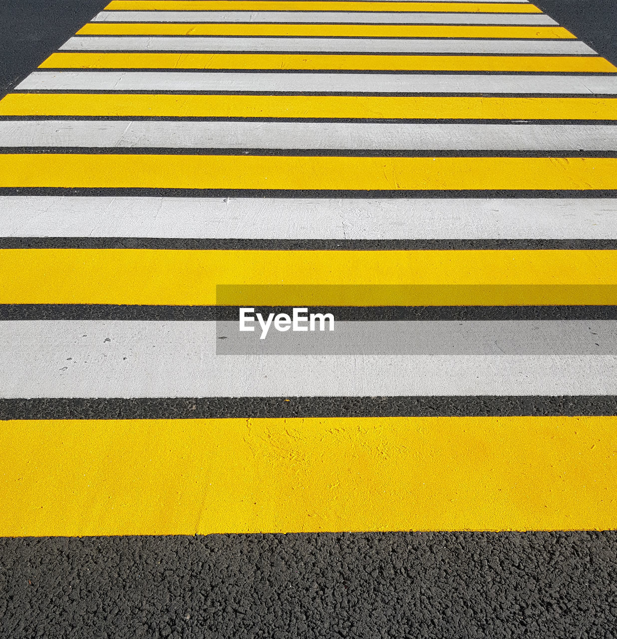 yellow, road marking, marking, striped, crosswalk, road, symbol, transportation, sign, zebra crossing, crossing, city, no people, line, pattern, asphalt, lane, street, high angle view, pedestrian crossing, day, architecture, outdoors, communication, full frame, floor, backgrounds, road surface