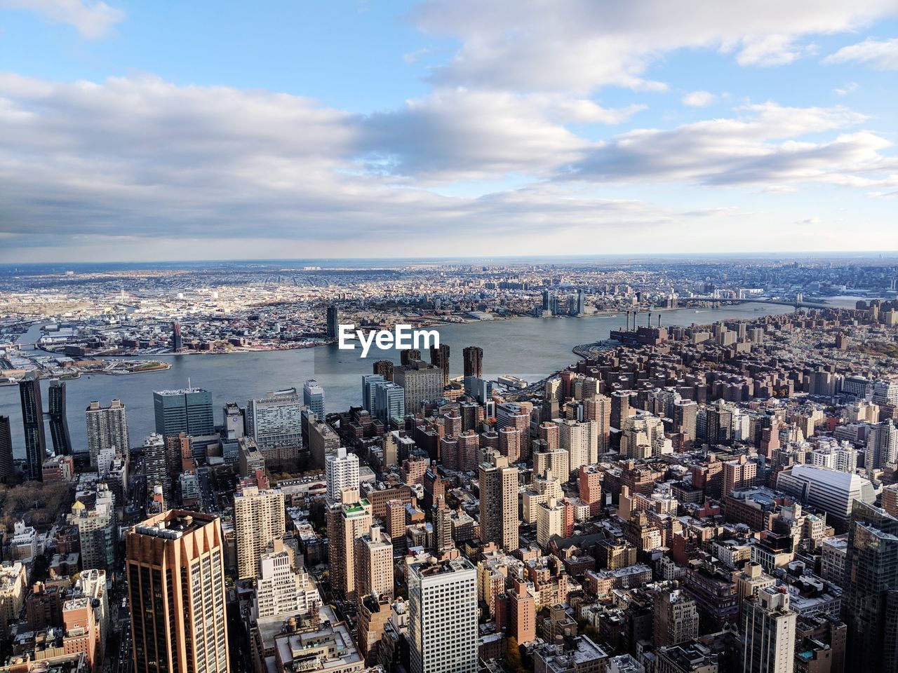 High angle view of cityscape against cloudy sky