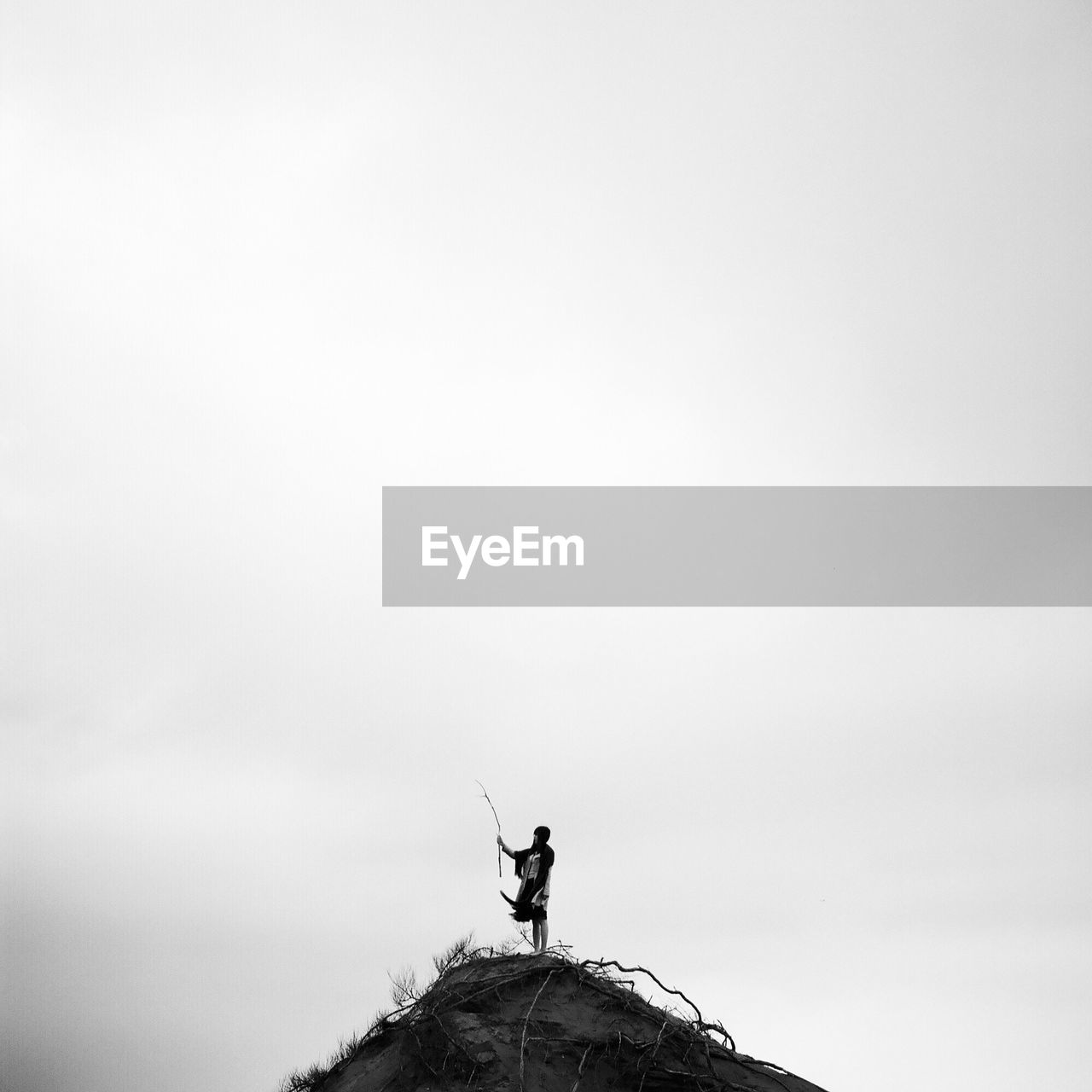 LOW ANGLE VIEW OF STATUE ON ROCK FORMATION