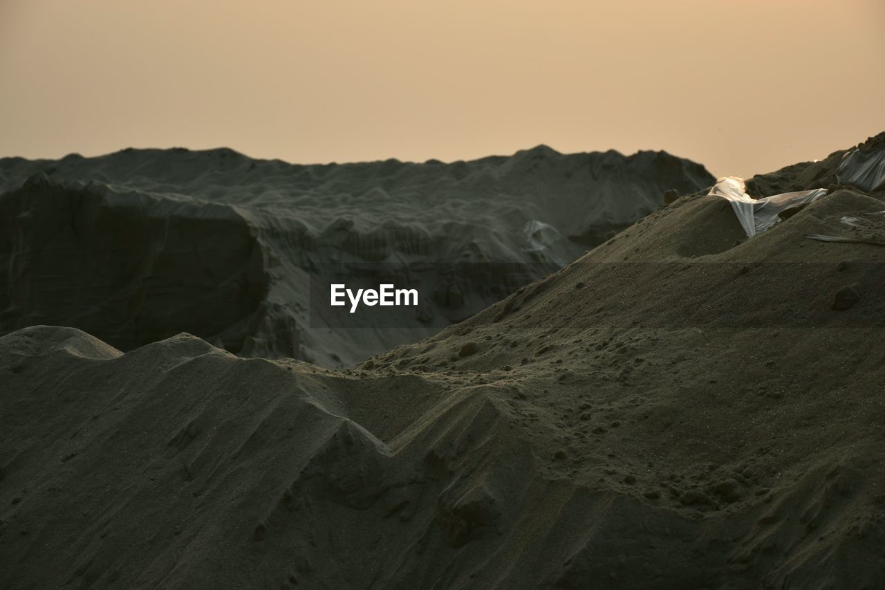 Scenic view of desert against sky during sunset