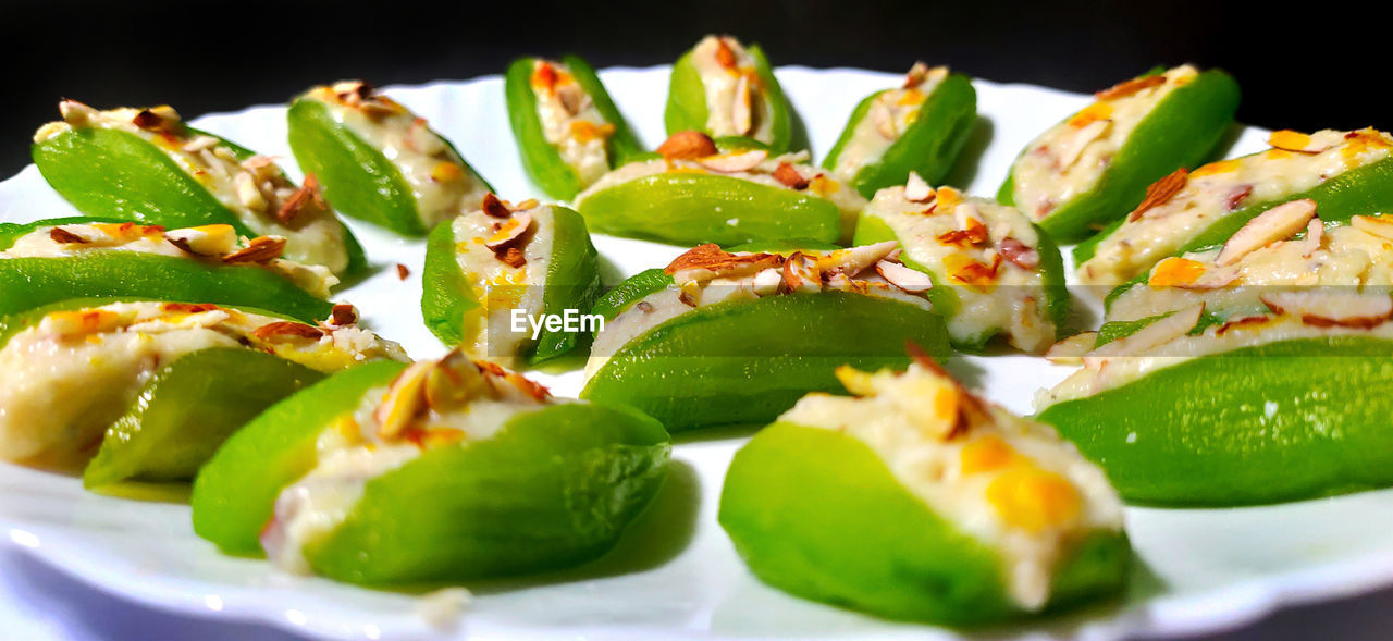 Pointed gourd sweets isolated in black background. diwali special gourd sweet