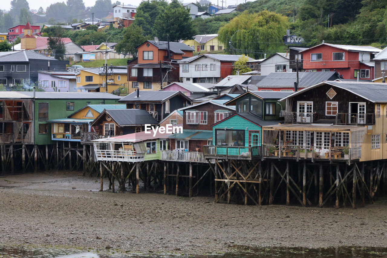 houses by sea against sky